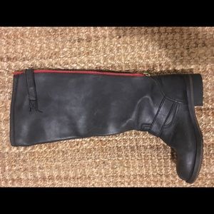 Knee high Steve Madden boots with red zipper.